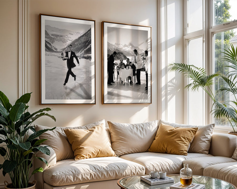 Living room with a beige sofa, decorative pillows, and framed black and white photos on the wall.