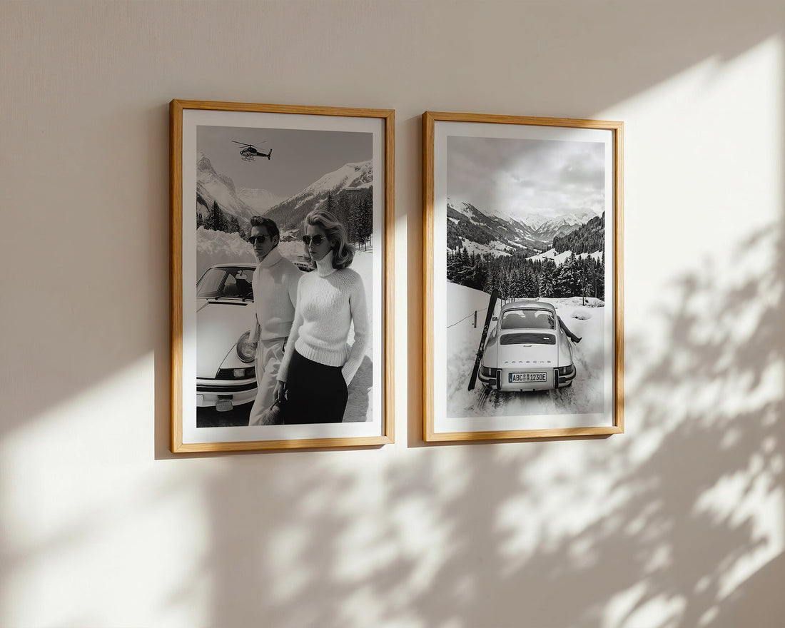 Two framed black and white photos of a couple and a 911 Porsche car on a mountain wall.
