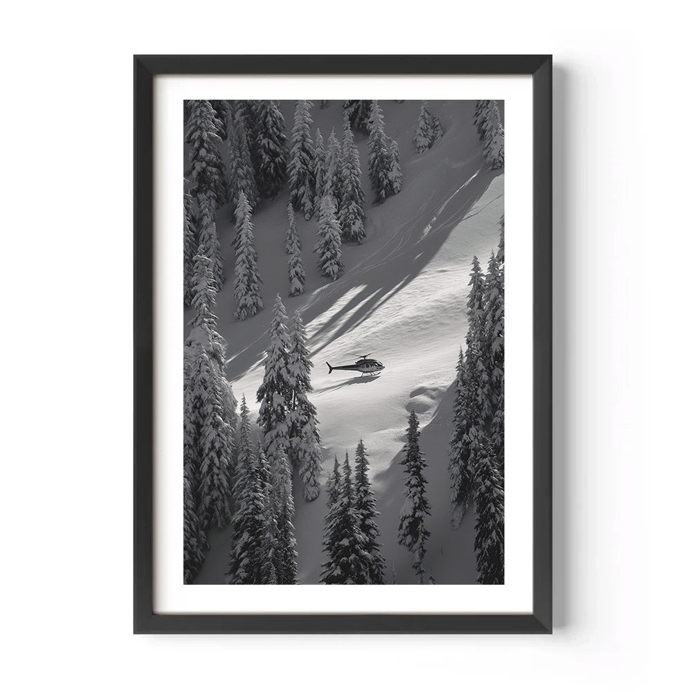 Framed black and white print of a helicopter on a snowy mountain slope with trees.