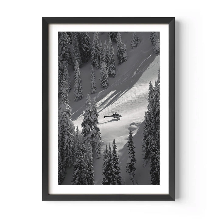 Framed black and white print of a helicopter on a snowy mountain slope with trees.