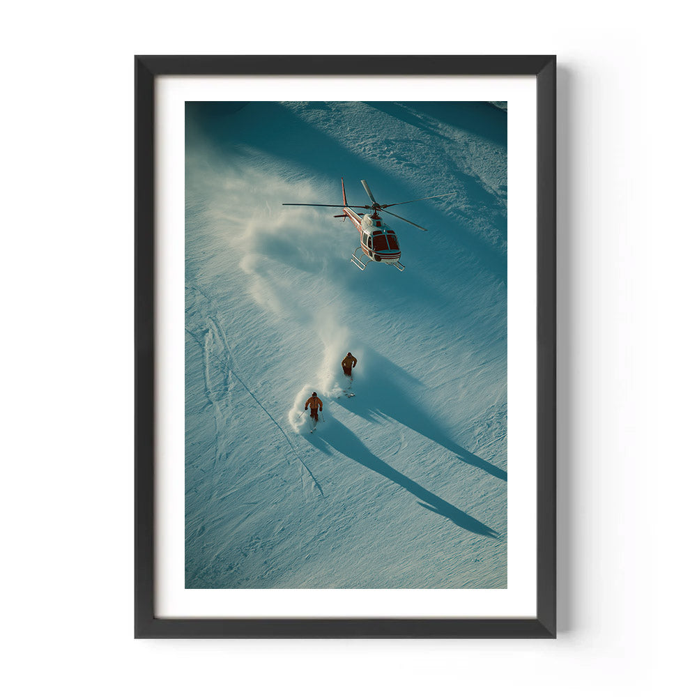 Framed photograph of a helicopter and two people on skis in a snowy landscape.