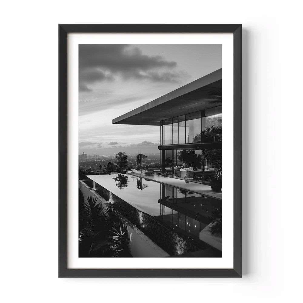 Framed black and white photograph of a modern house with an infinity pool.