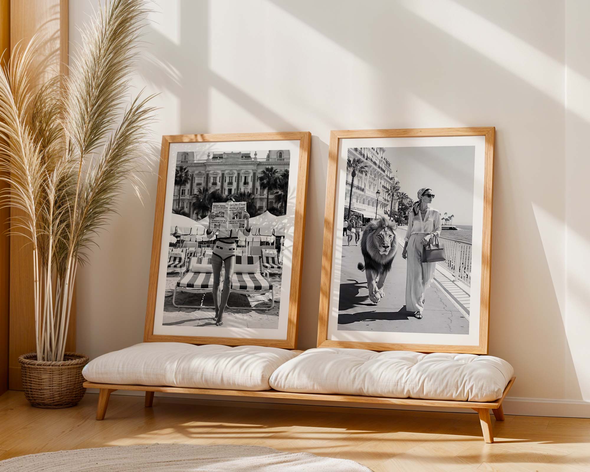 Two framed black and white photos on a wall above a wooden bench with cushions.