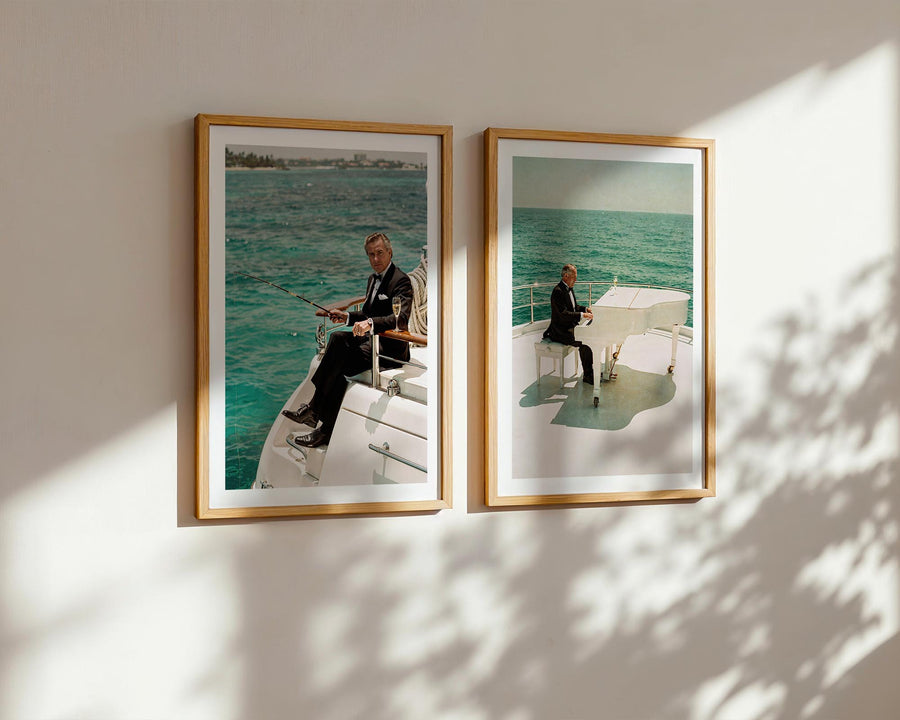 Two framed pictures of a man on a boat hanging on a wall.