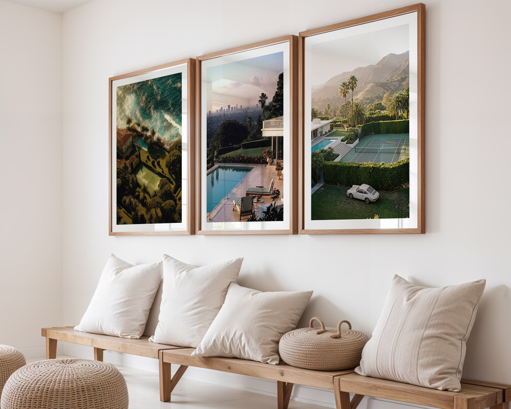 Three framed artworks of landscapes on a wall above a wooden bench with cushions.