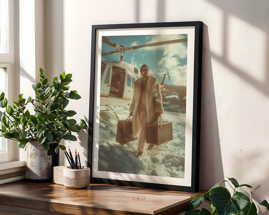 Framed artwork of a person with suitcases on a boat, placed on a wooden surface with plants.