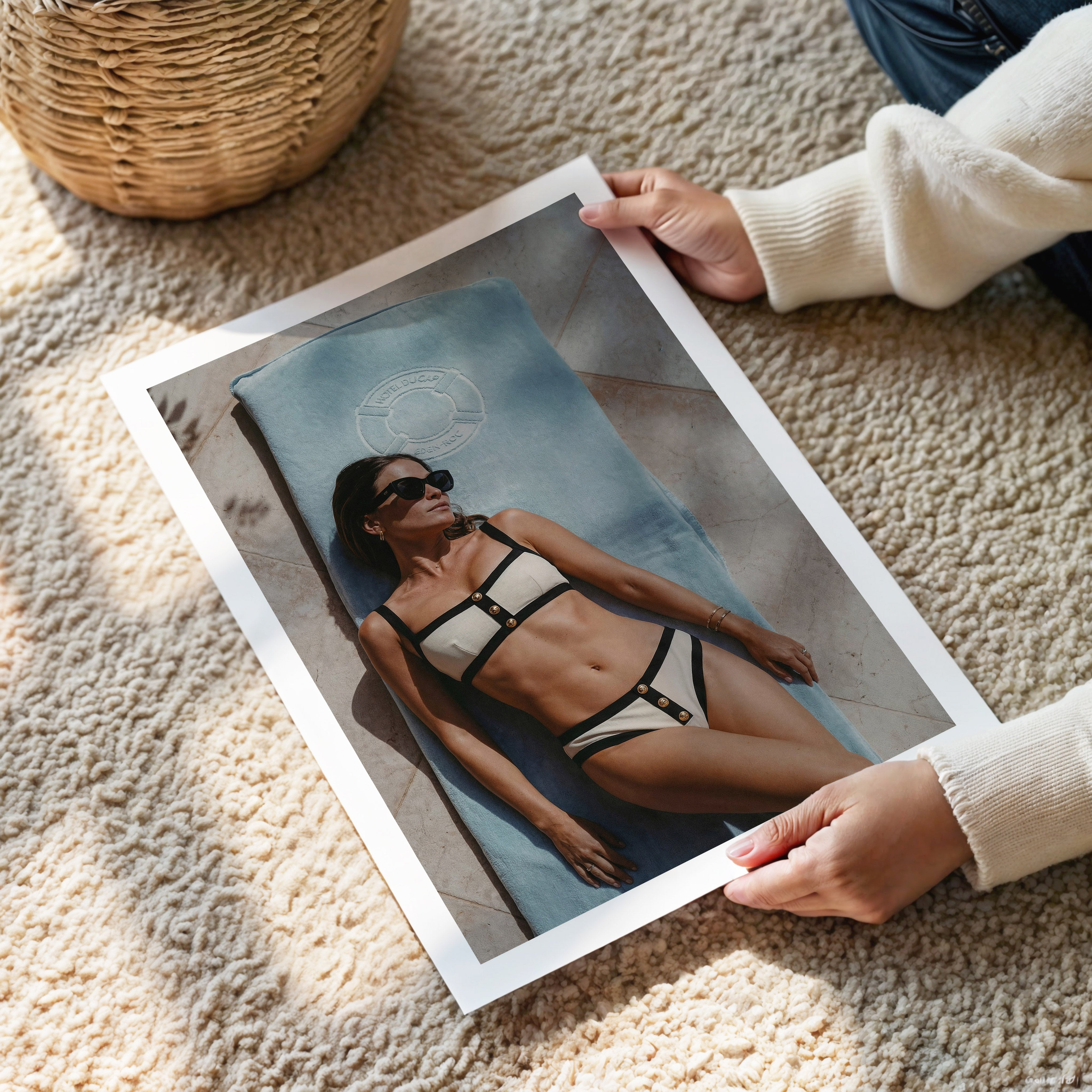Person holding a photo of a woman in a bikini at Hotel du Cap-Eden-Roc