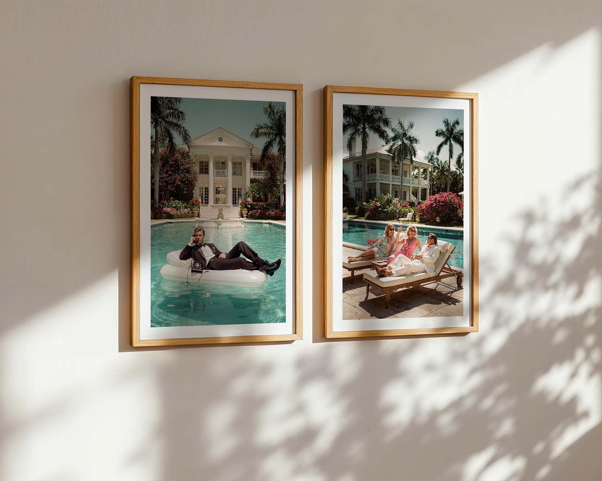Two framed photographs of people by a poolside on a wall with sunlight casting shadows.