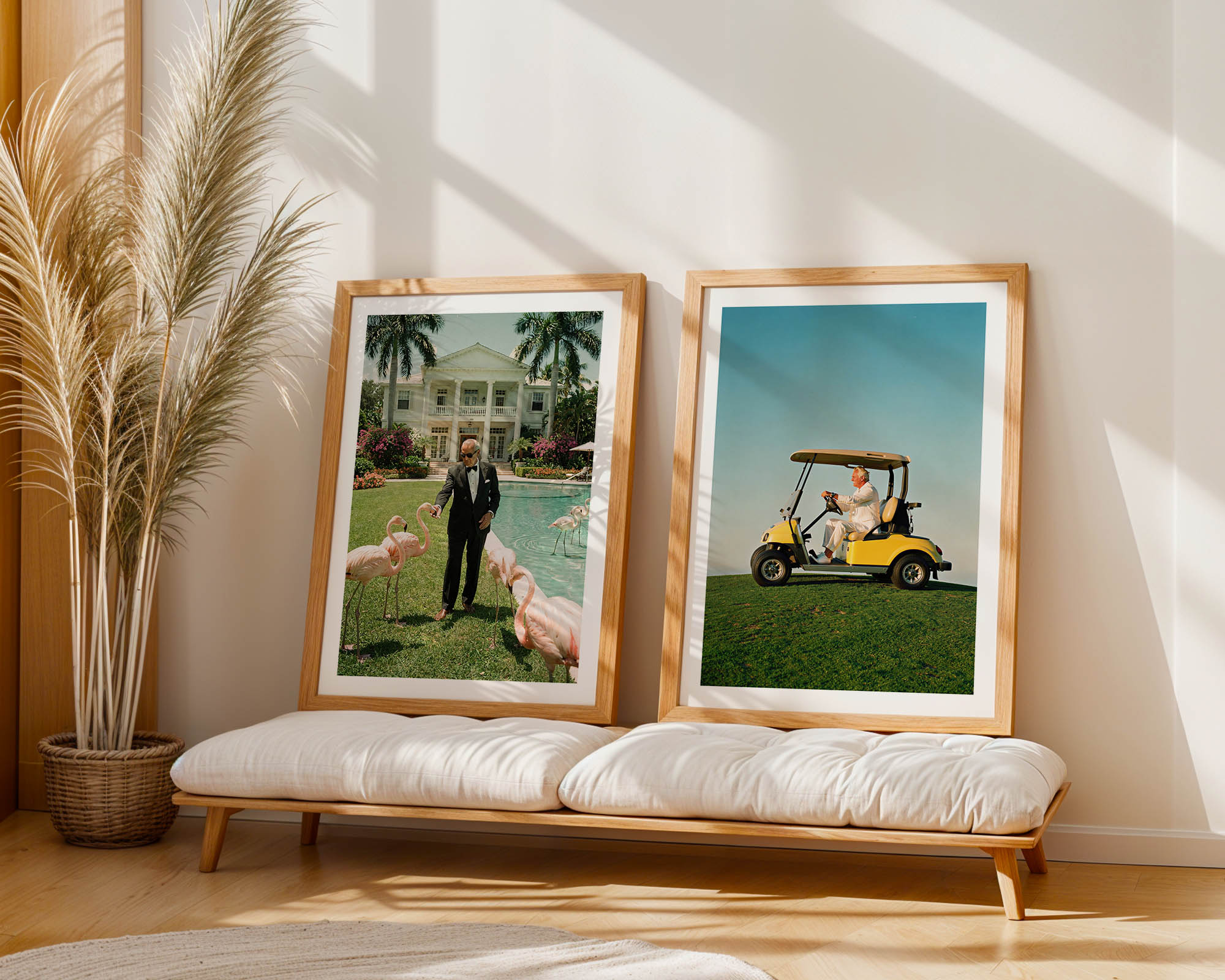 Two framed pictures on a wooden bench with a plant in the background