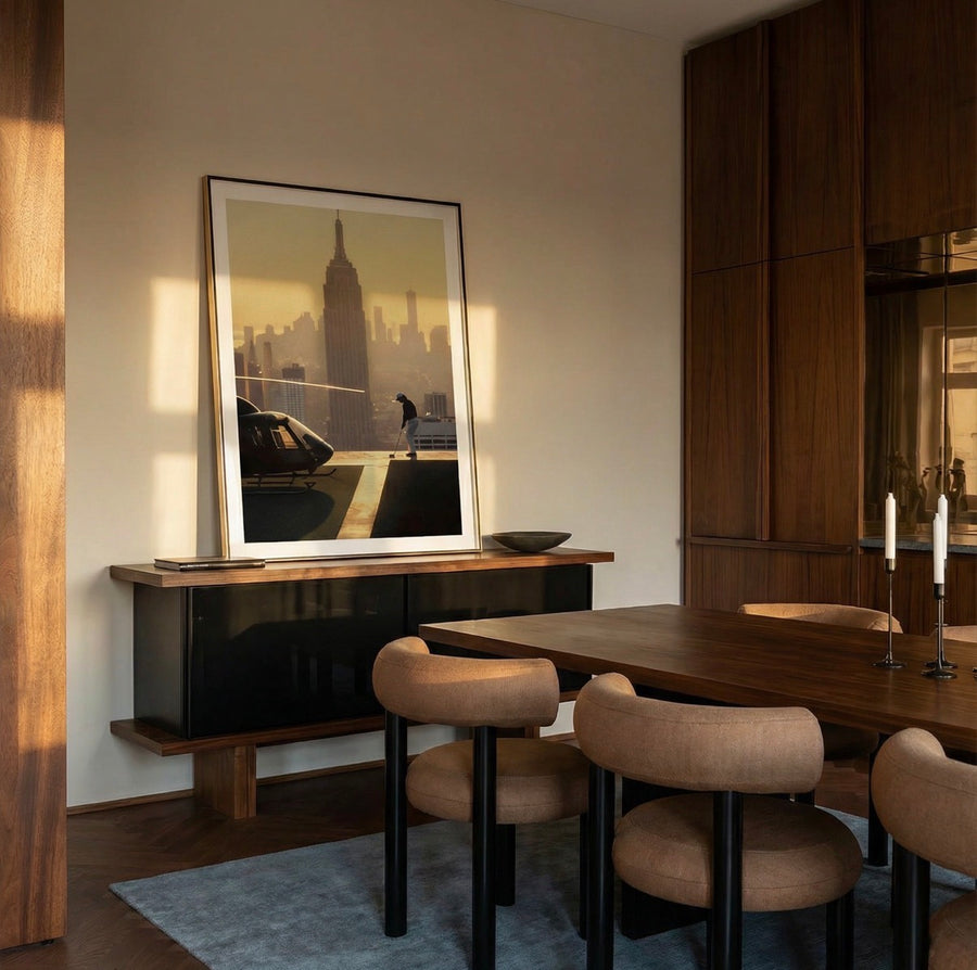 Dining room with wooden table, chairs, and a large mirror on the wall.