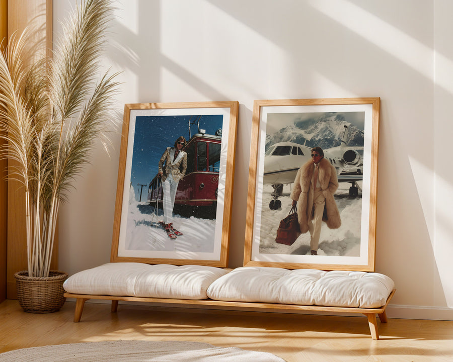 Two framed photographs of people in snowy landscapes on a wooden bench with a plant in the corner.