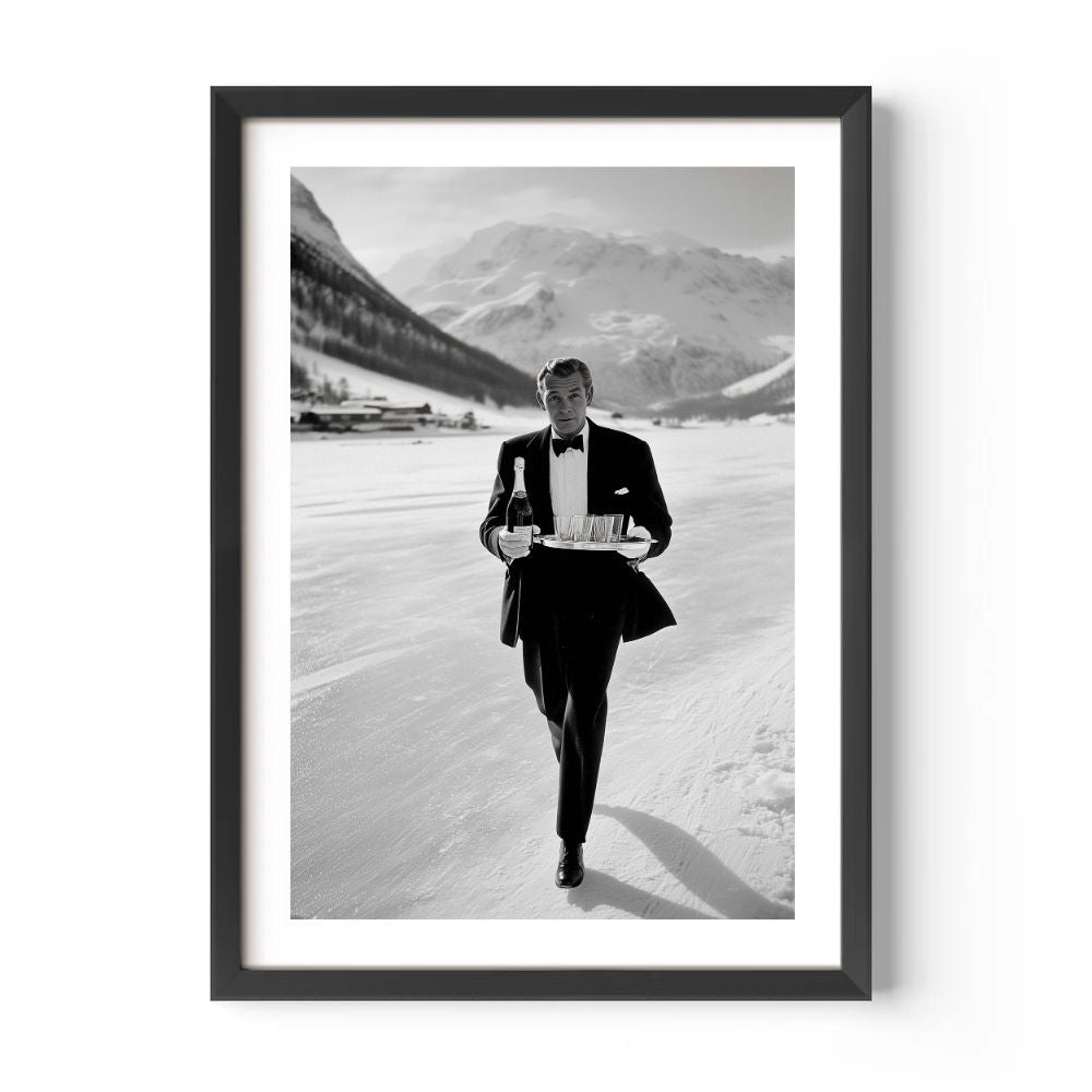 Framed black and white photograph of a man in a tuxedo walking with a tray in a mountainous landscape.