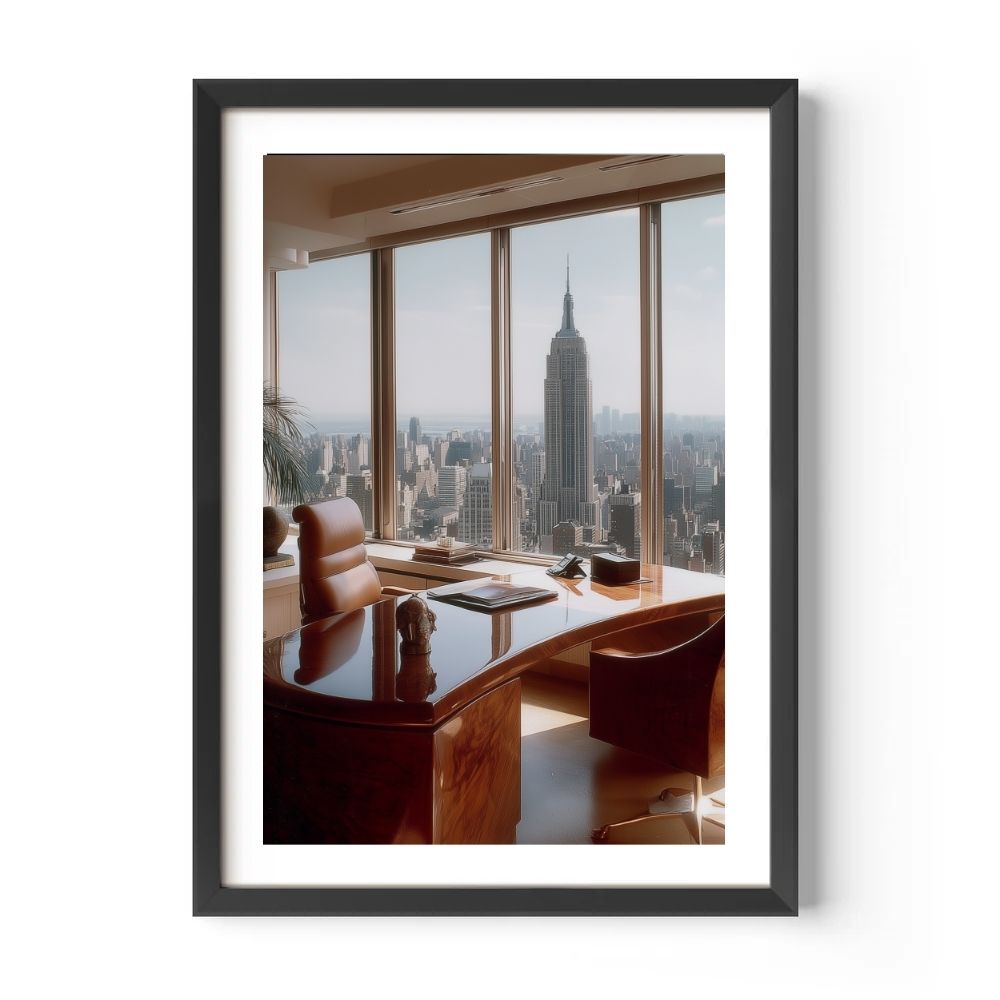 Framed photo of a cityscape with a desk and chairs inside, featuring the Empire State Building.