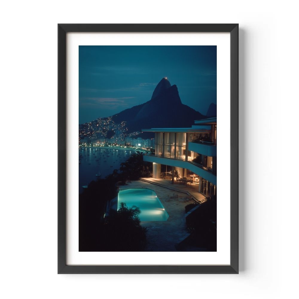 Framed photograph of a nighttime scene with a pool and mountain view.