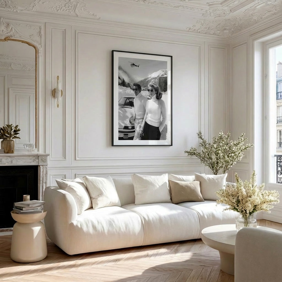 Modern living room with white sofa, decorative wall art, and plants.
