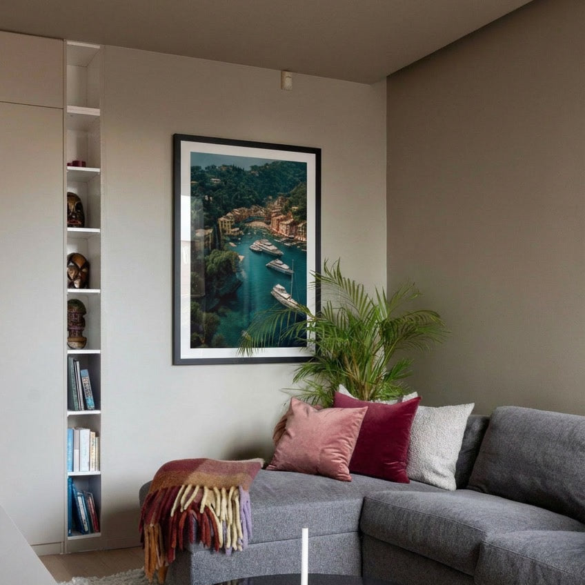 Living room with a gray sofa, colorful pillows, and a framed artwork on the wall.