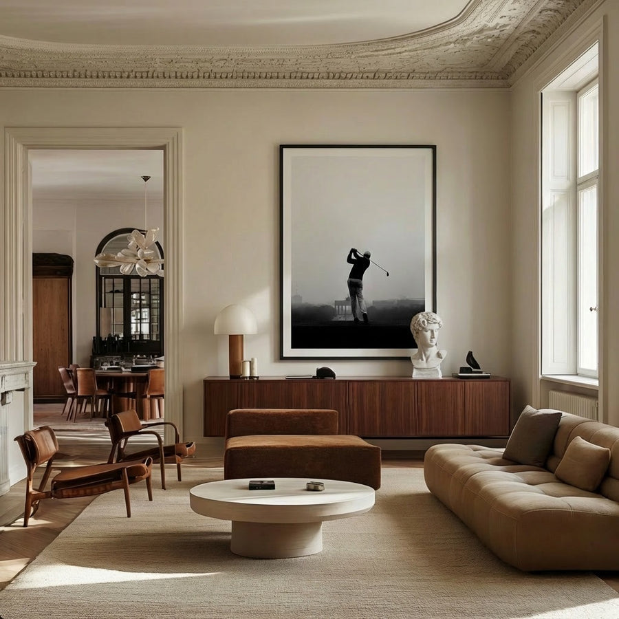 Modern living room with a large painting of a golfer, a sofa, and a coffee table.