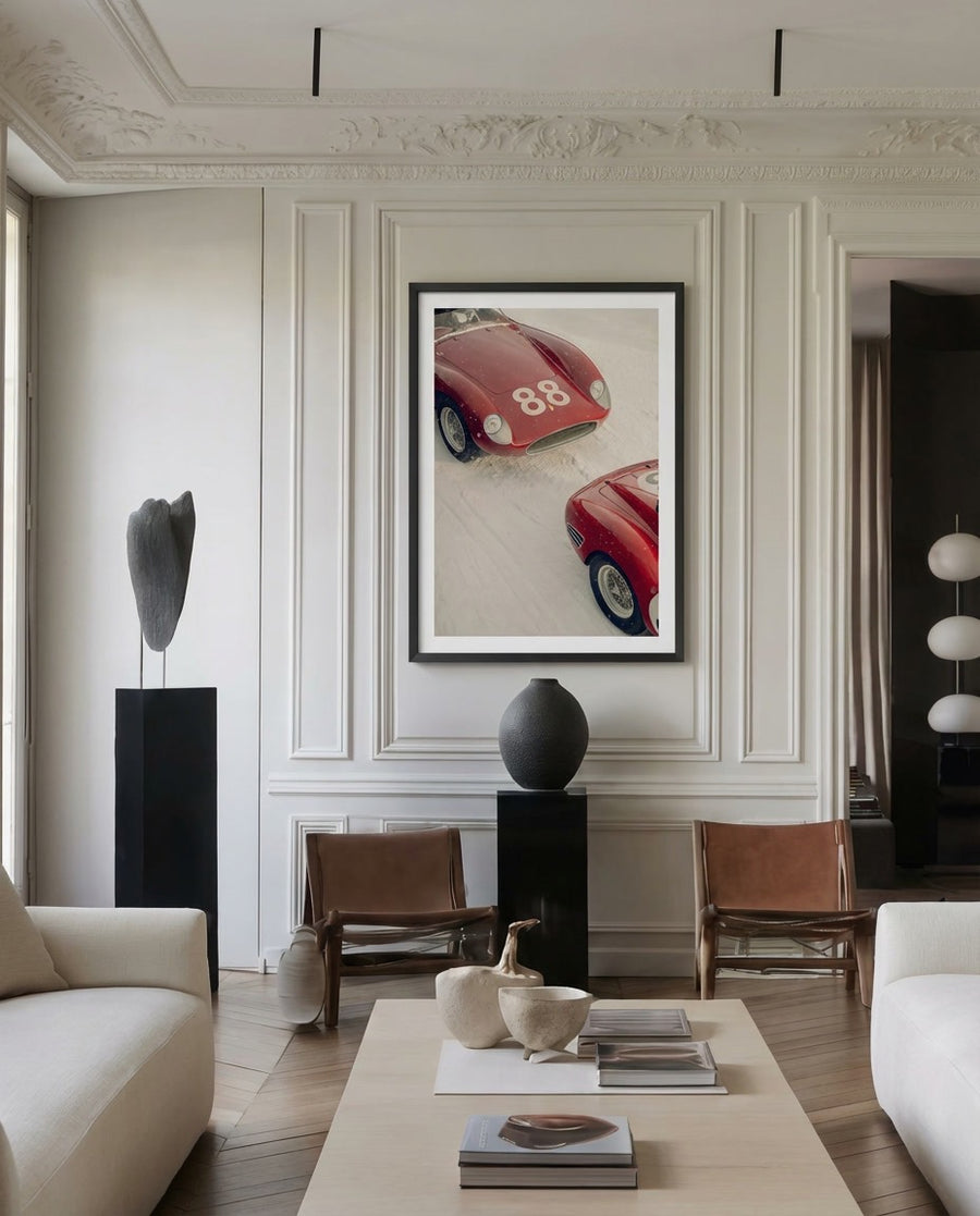 Living room with a red sports car print on the wall, white walls, and modern decor.