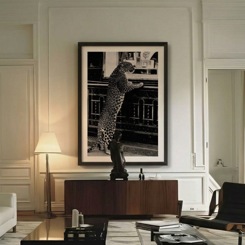 Modern living room with a large framed photograph on the wall, white sofa, and dark coffee table.