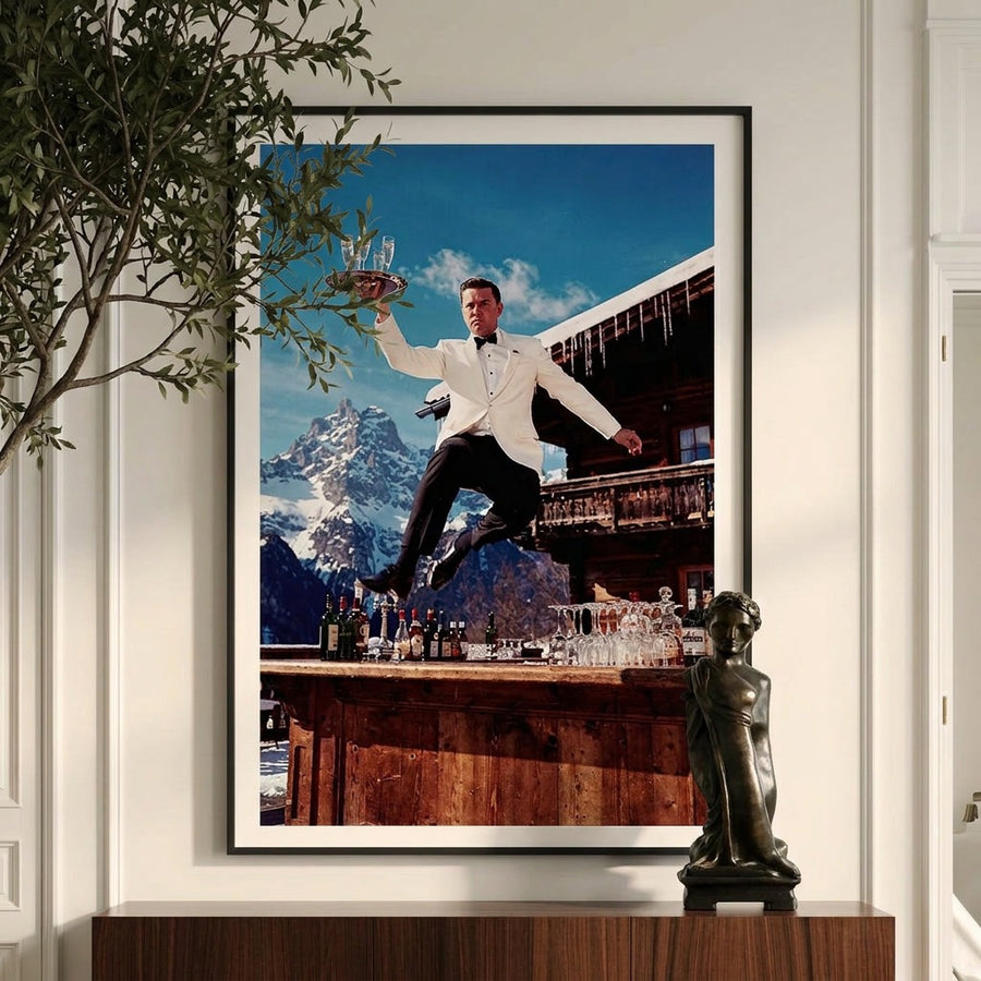 Framed artwork of a man in a tuxedo jumping over a bar with mountains in the background.