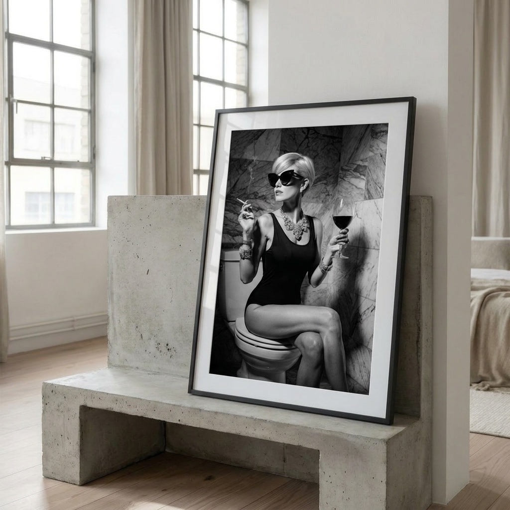 Framed black and white artwork of a woman on a toilet in a modern room.