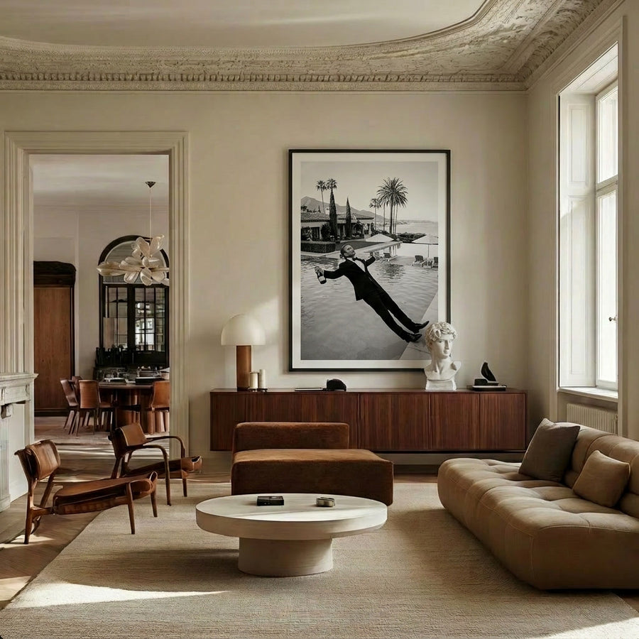 Modern living room with a large sofa, coffee table, and wall art.