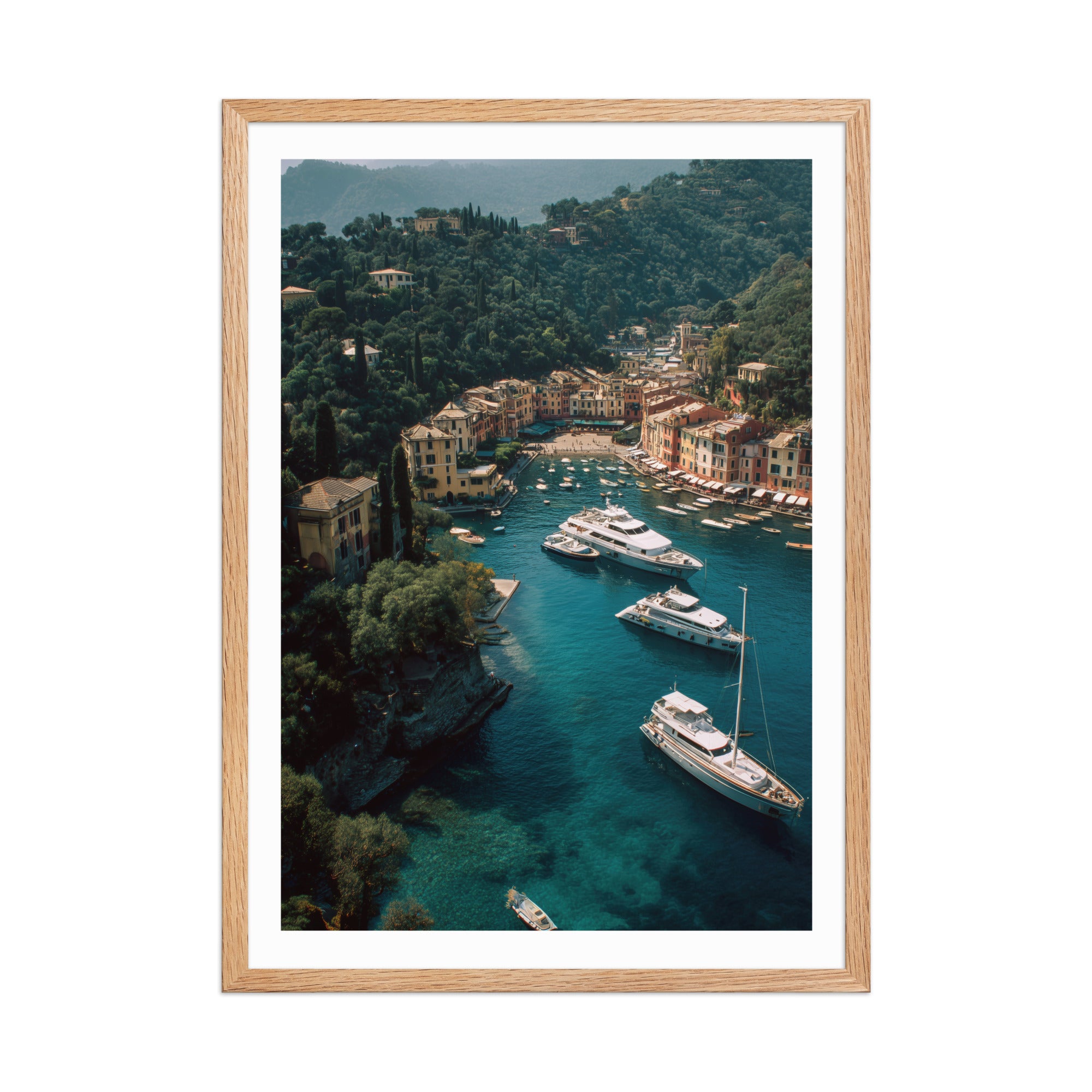 Framed artwork of a coastal town with boats and a clear blue sea.
