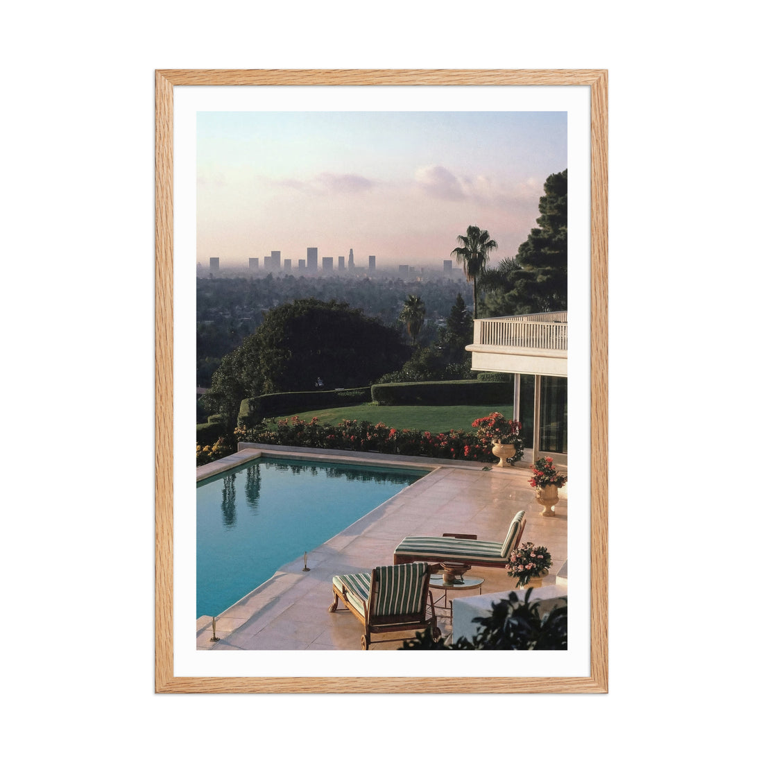 Framed photograph of a poolside scene with Los Angeles skyline in the background