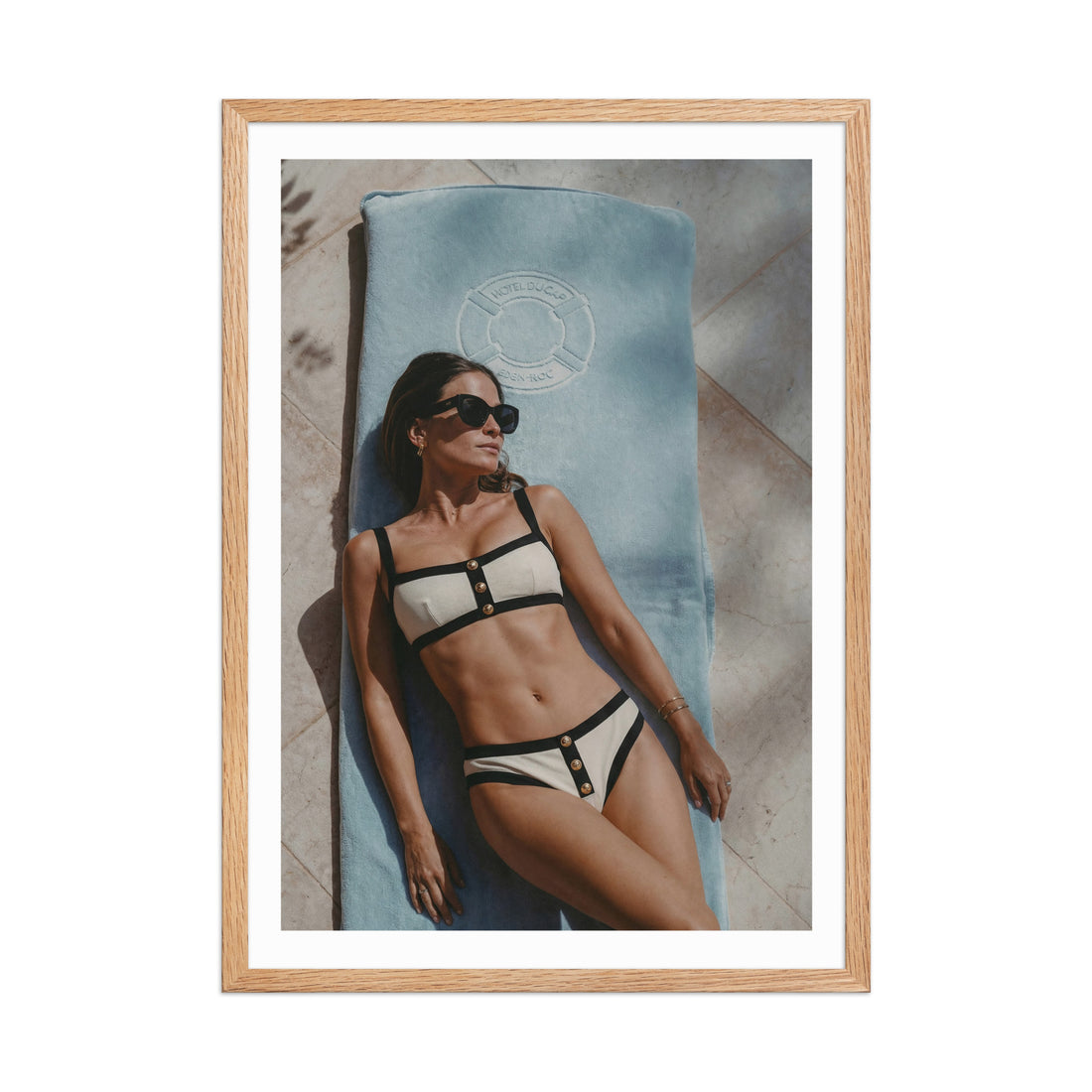 Framed photo of a woman in a Chanel bikini lying on a towel at Hotel du Cap-Eden-Roc