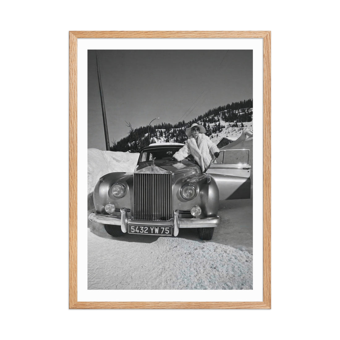 Framed black and white photograph of a vintage car in a snowy landscape.