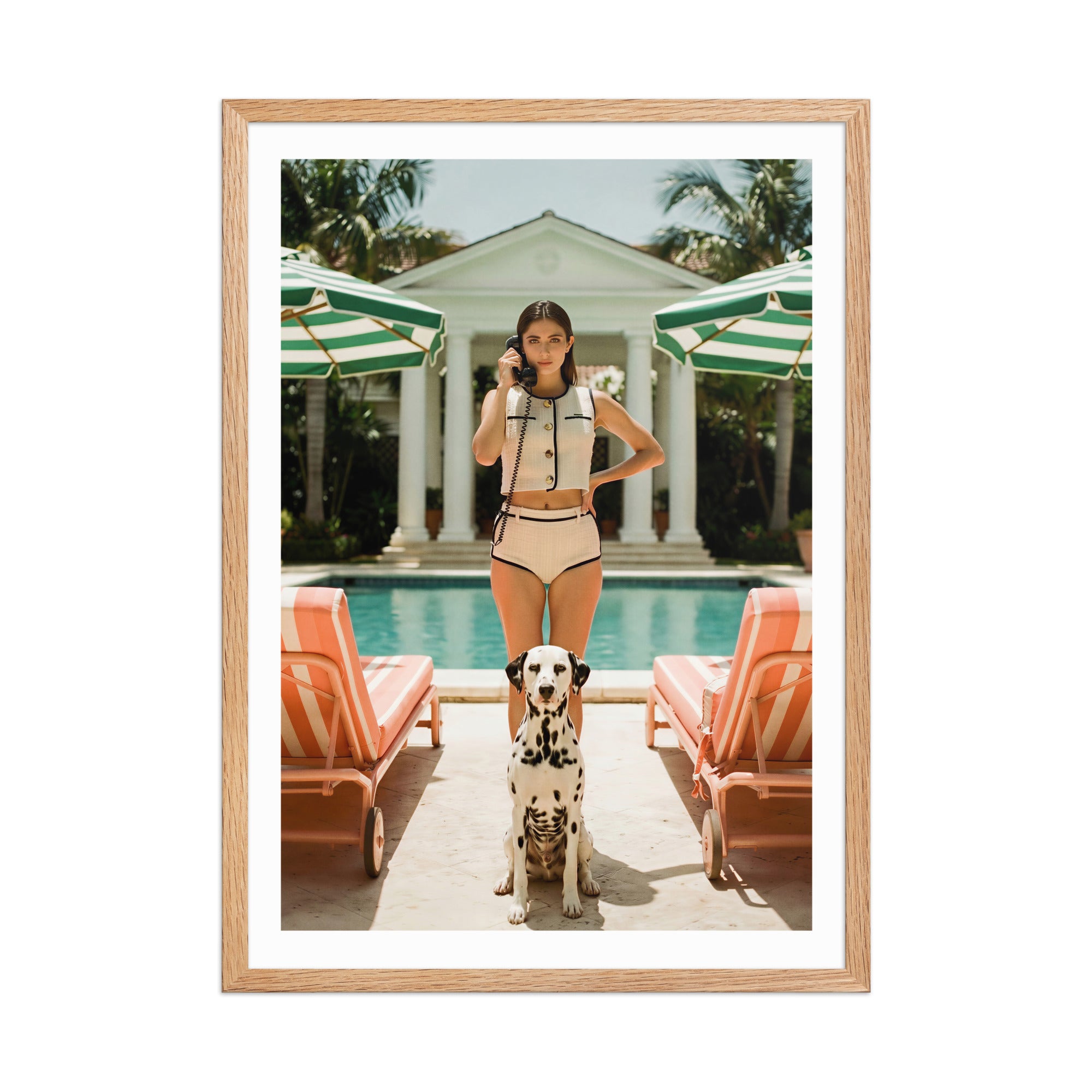 Framed photo of a woman and a Dalmatian dog by a poolside with lounge chairs and umbrellas.