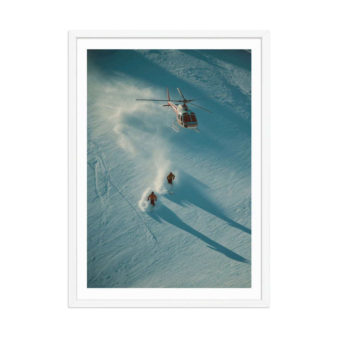 Helicopter flying over two people on skis in a snowy landscape