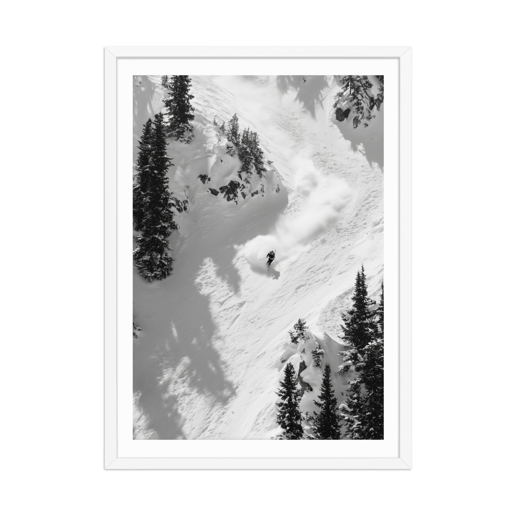 Black and white photograph of a skier descending a snowy mountain with trees.
