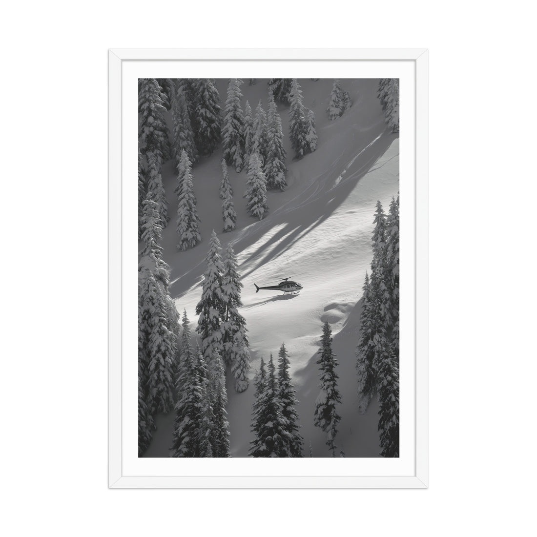 Framed black and white print of a helicopter flying over a snowy landscape with trees.