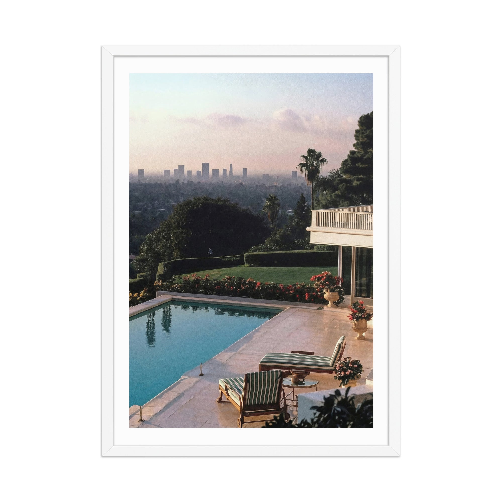 Framed photograph of a poolside scene  in Los Angeles with lounge chairs and a city skyline in the background.