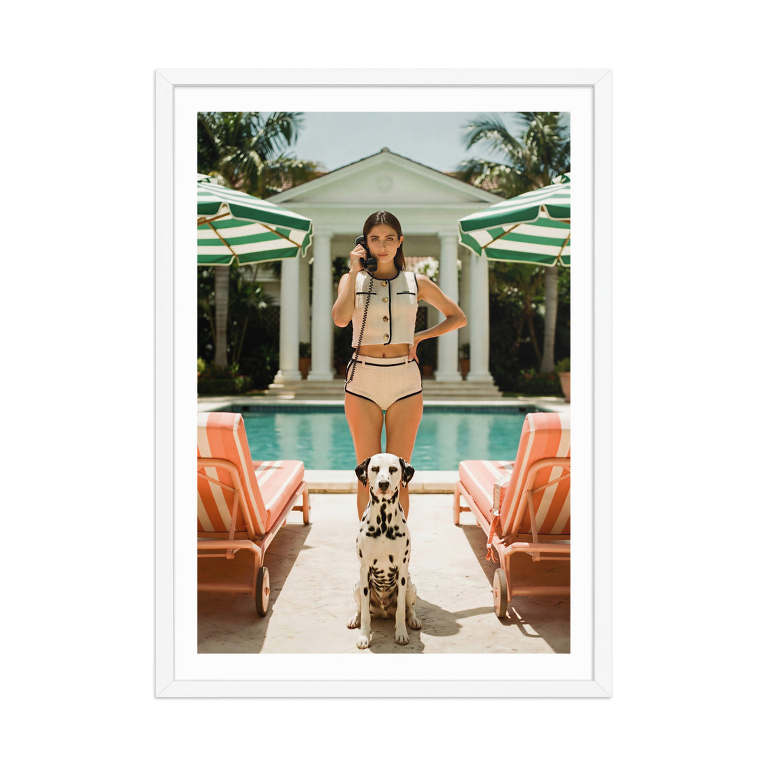 Woman in swimsuit with a dog by a poolside with lounge chairs and umbrellas.