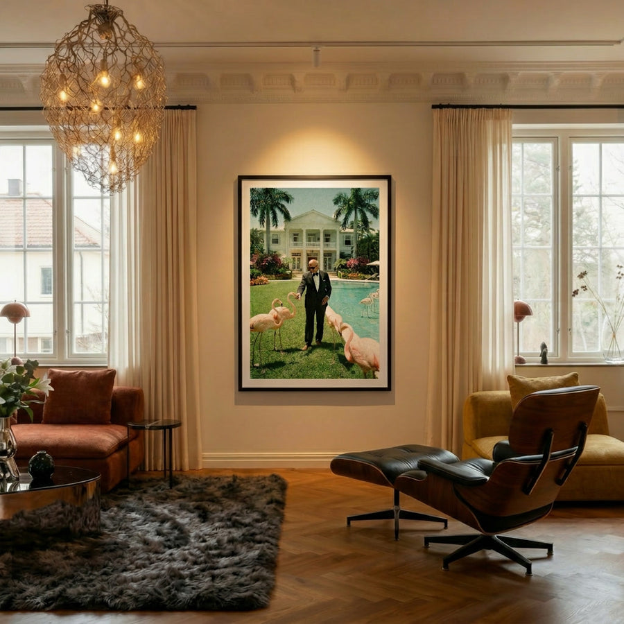 Living room with a painting of a man with pigs by a pool, a chandelier, and a modern chair.