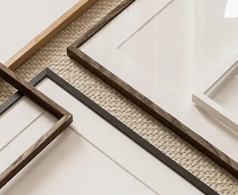 Collection of wooden picture frames on a textured surface