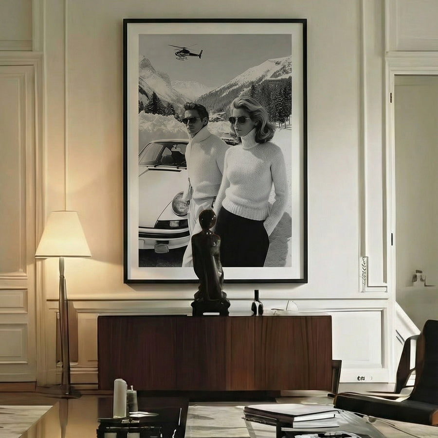 Modern living room with a large framed black and white photograph on the wall, a wooden desk, and stylish furniture.