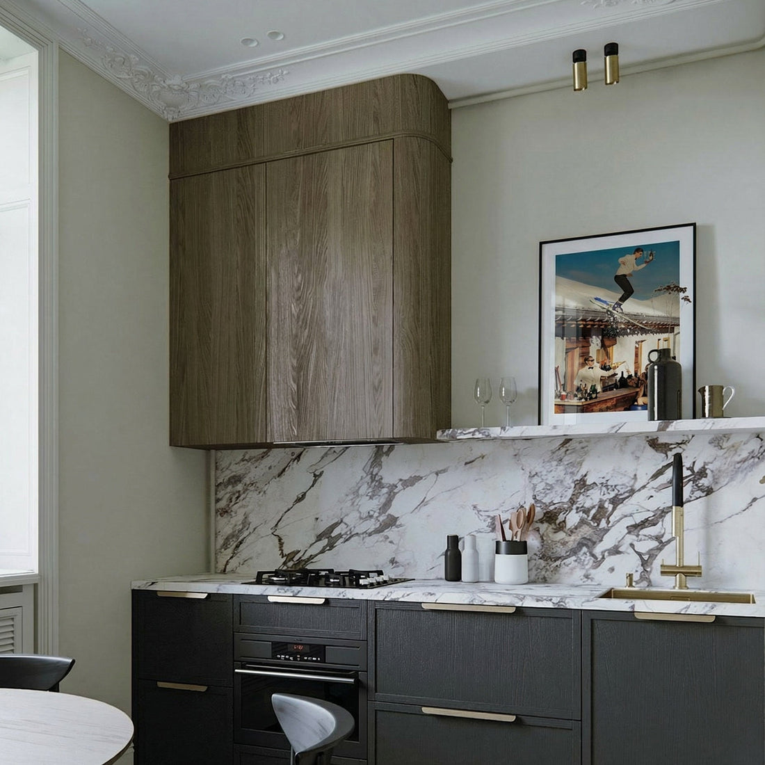 Modern kitchen with dark cabinets, marble backsplash, and a painting on the wall.