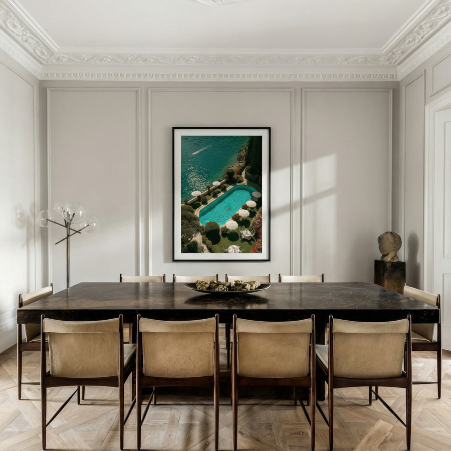 Dining room with a large table and chairs, featuring a framed artwork on the wall.