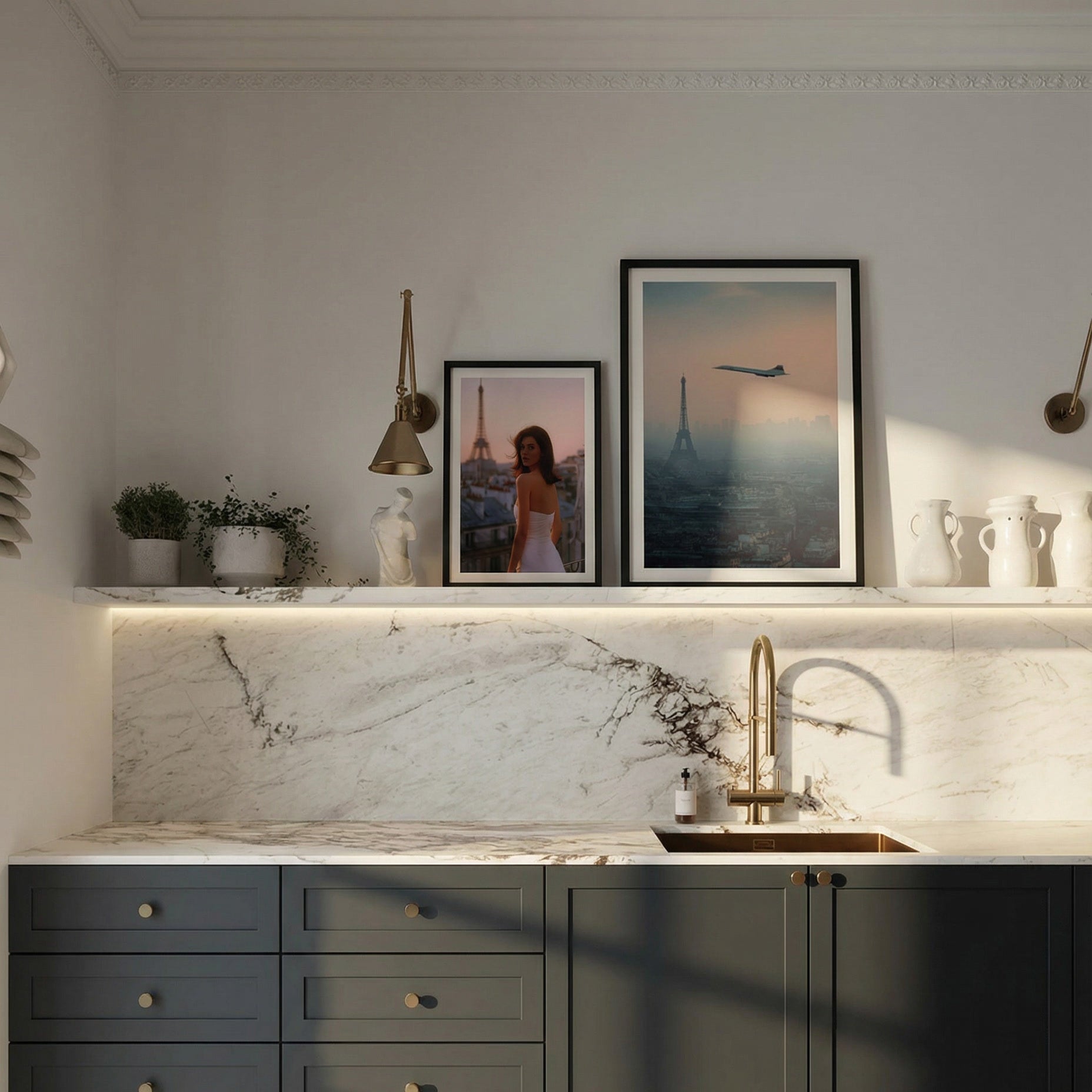 Modern kitchen with dark green cabinets, marble countertop, and framed pictures on the wall.