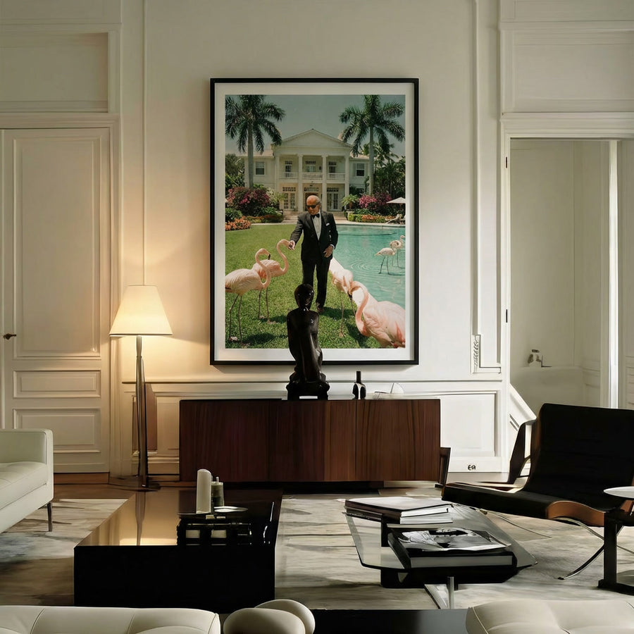 Modern living room with a large framed picture of a man with flamingos on a wall.