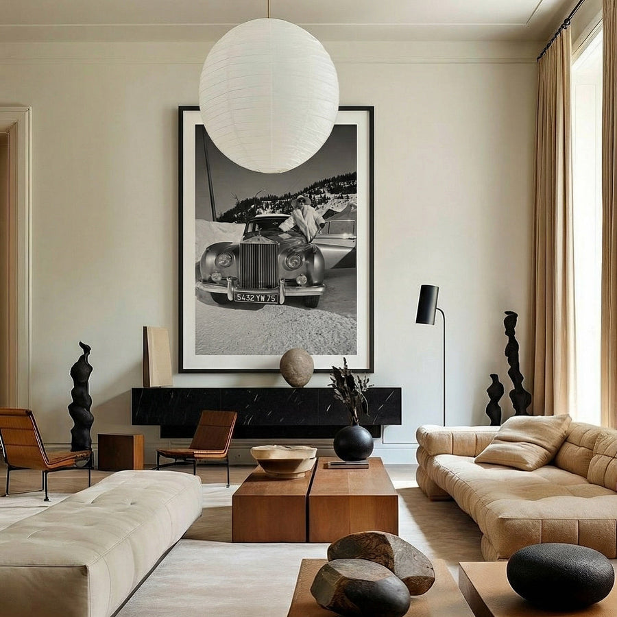 Modern living room with a large sofa, coffee table, and decorative elements.